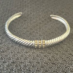 Silver tone bracelet with gold tone details  in the middle.